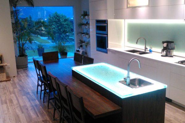 A kitchen with a spacious island featuring a sink, perfect for preparing meals and socializing.